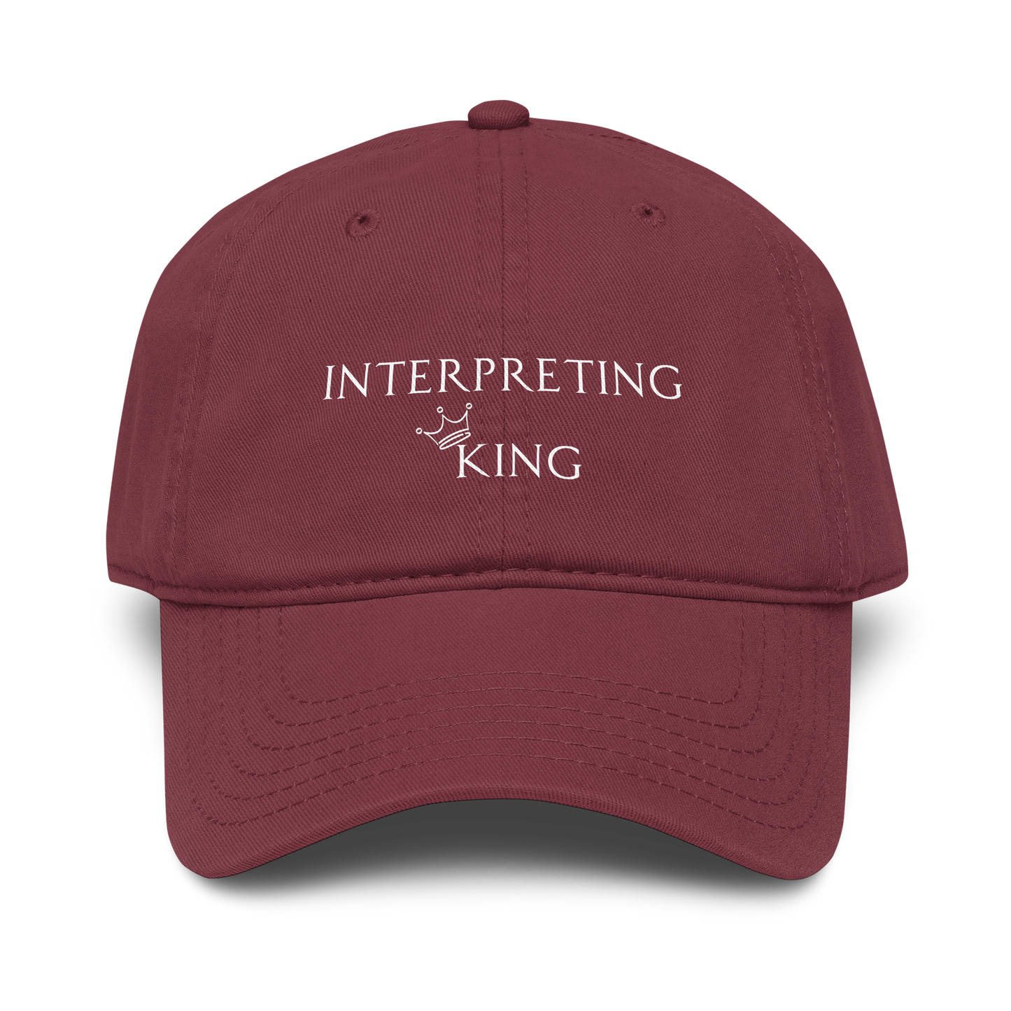 Red baseball cap with white text "Interpreting King" with a small crown on top of the letter K in King.