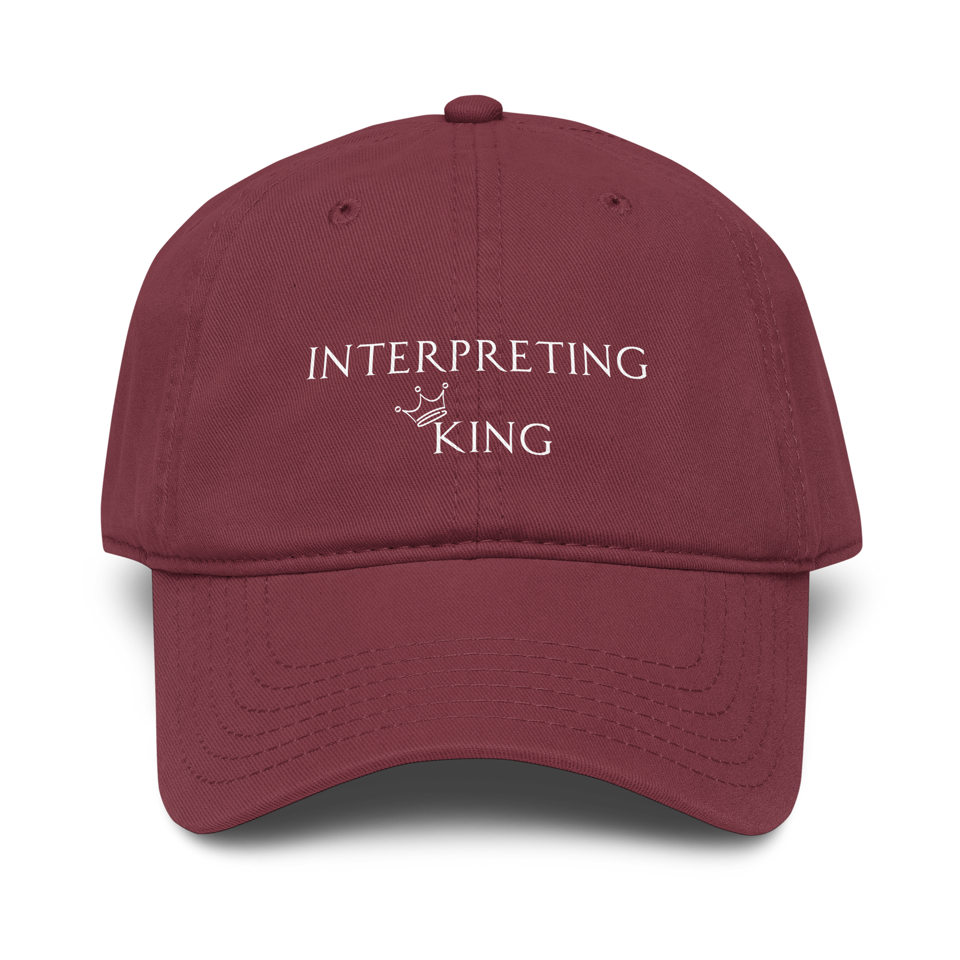 Red baseball cap with white text "Interpreting King" with a small crown on top of the letter K in King.